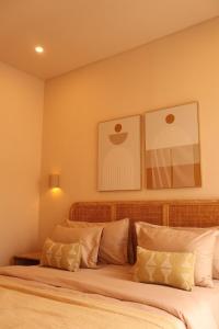a bedroom with a large bed with white pillows at Pasir 3 - A stylish 2 bed villa in Bingin w pool in Bingin Beach +15 photos