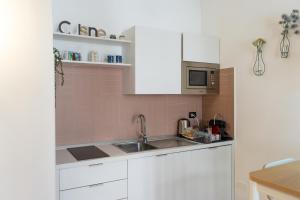 a kitchen with a sink and a microwave at Naples Soul - city center in Naples