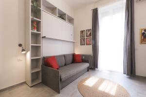 a living room with a couch and a table at PrimoPiano - Sempione in Milan