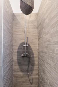 a shower with a shower head in a bathroom at PrimoPiano - Sempione in Milan +38 photos