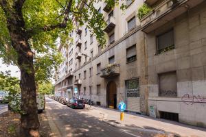 a building with graffiti on the side of a street at PrimoPiano - Sempione in Milan