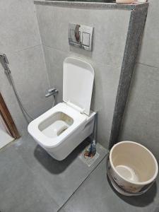 a bathroom with a toilet in a stall at Satymev Serene flats in Ahmedabad