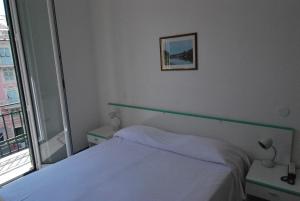 Postel nebo postele na pokoji v ubytování Albergo La Vela