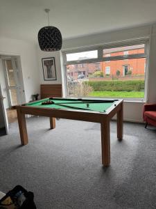 a billiard table in a room with a window at Spacious House Parking Pool Table in Balderton