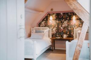 a bedroom with a bed and a wall covered in flowers at Three Cocks Hotel in Brecon