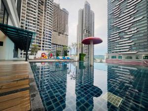 a pool in the middle of a city with tall buildings at Reizz Residence by Perkasa Suites in Batu Empat