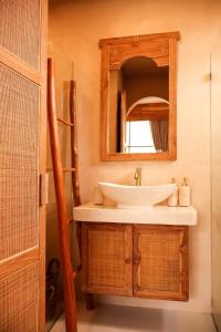 a bathroom with a sink and a mirror at Pasir 5 - A stylish 2 bed villa in Bingin w pool in Bingin Beach