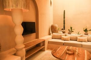 a living room with a couch and a table at Pasir 5 - A stylish 2 bed villa in Bingin w pool in Bingin Beach