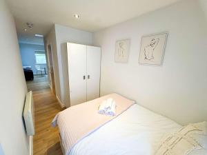 a bedroom with a bed with a towel on it at Harford House Studios 21 - Hopewell in Bristol