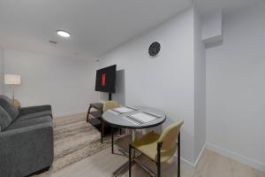 a living room with a table and chairs and a couch at Modern Suite by Hospital 2 Near Transit, Wi-Fi, Netflix in Edmonton