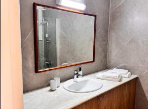 a bathroom with a sink and a mirror at Family House in Limassol