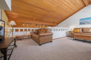 a living room with leather furniture and a wooden ceiling at RMR: Cinquefoil 1613 Condo in The AspensWilsonWY in Wilson