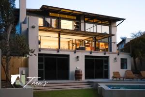 a large house with a pool in front of it at The Bishops Villa in Cape Town