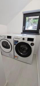 two washing machines with a television on top of them at Park home in Baia Mare