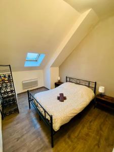 a bedroom with a bed with a candle on it at Business Apparts Caudry in Caudry