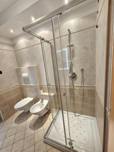 a bathroom with a shower and a toilet and a sink at Amanda 2 Apartments in Sarche di Calavino