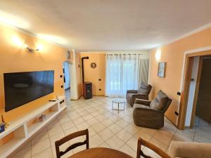 a living room with a large flat screen tv at Amanda 2 Apartments in Sarche di Calavino