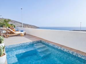 a swimming pool with a view of the ocean at Seaside Home Jacuzzi Pool Free Surf Retreat in El Médano