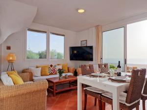 a living room with a couch and a table at Seaside Home Jacuzzi Pool Free Surf Retreat in El Médano