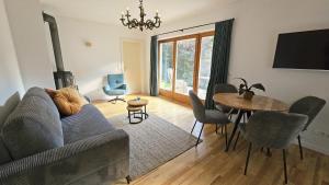 a living room with a couch and a table at Almrose Zauber by Alpenchalet Almrose in Oberau