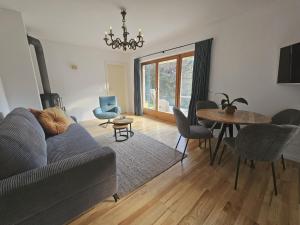 a living room with a couch and a table at Almrose Zauber by Alpenchalet Almrose in Oberau