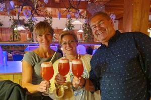 a group of people holding up glasses of beer at pfefferHÄUSL in Regen