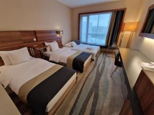 a hotel room with two beds and a window at Warsaw Plaza Hotel in Warsaw +55 photos