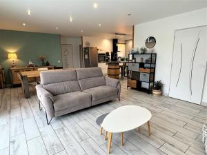 a living room with a couch and a table at Villa nature in Léon