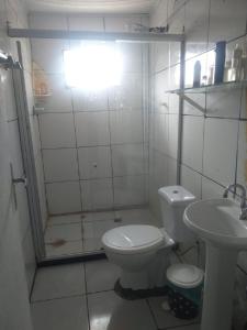 a bathroom with a toilet and a sink at Pousada Coração de Mãe in Salvador