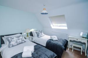 a bedroom with two beds and a desk and a window at Manby Louth 5BR Home 3Bath Parking WiFi in Manby