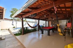 a patio with a hammock and a pool table at Casa no Centro de Pirenópolis in Pirenópolis