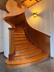 a staircase in a building with a wooden stair case at Ewa & Maude Hotel in Gothenburg +31 photos