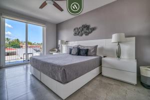 a bedroom with a bed and a large window at Centric 2BR Condo- Balcony - Rooftop Pool in Bucerías