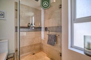 a bathroom with a shower with a glass door at Centric 2BR Condo- Balcony - Rooftop Pool in Bucerías +38 photos