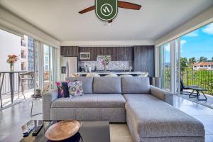 a living room with a couch and a kitchen at Centric 2BR Condo- Balcony - Rooftop Pool in Bucerías