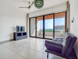 a living room with a couch and a tv at 2BR Condo with Private Terrace - Near to the Beach in Nuevo Vallarta 