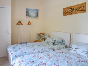 a bedroom with two beds with blue comforter at Bryn Melyn - Uk6518 in Frongoch +6 photos