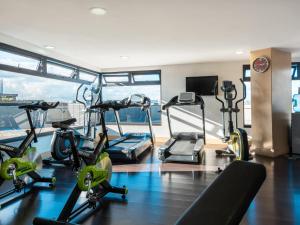 a gym with treadmills and exercise bikes in a building at Novotel Bogota Parque 93 in Bogotá