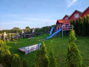 a yard with a playground with a slide at Apartament KaJa in Rewal