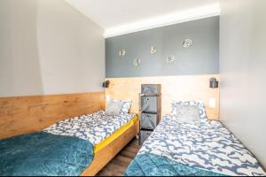 a bedroom with two beds in a room at Apartament KaJa in Rewal