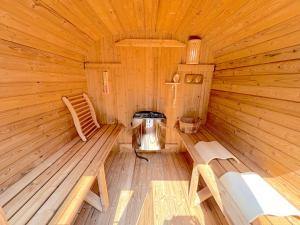 a wooden cabin with a bench and a stove in it at -New Open- グランディオーソ沖縄プールヴィラ恩納14 in Onna +13 photos