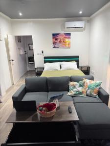 a living room with a couch and a bed at Tranquil Vistas of Marigot in Marigot