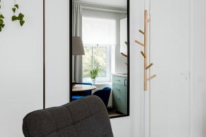 a mirror in a room with a chair and a table at Anna Studio in Tallinn