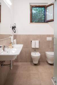 a bathroom with a sink and a toilet at Policaretto Rooms by Calabria Stay in Torretta
