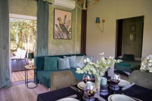 a living room with a couch and a table at Forest Resort House in Pašiliai