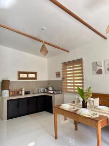 une cuisine avec une table en bois dans une pièce dans l'établissement Casa Ilios - a peaceful 2BR home in Poblacion 5, General Luna, à Catagnan