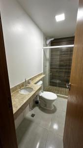 a bathroom with a toilet and a sink and a shower at Apartamento completo em Petrópolis in Petrópolis