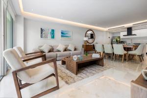 a living room with a couch and a table at Amazing Condo - Beach Access - Spa - Pool in Higuera Blanca