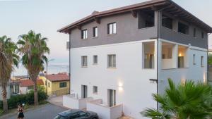 a white house with a gray roof at B&B Fiore di Cappero by Calabria Stay in Cariati