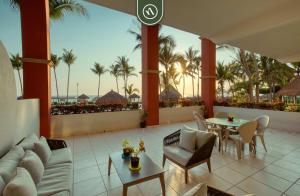 a living room with a couch and a table at Mexican Styled 2 BR Condo - Beachfront - Pool in Nuevo Nayarit